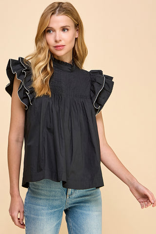 woman wearing a black ruffle sleeve top